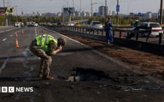 Kyiv bridge hit in further Russian drone attack as German chancellor makes surprise visit